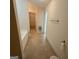Hall bathroom featuring tile floors, tub, toilet, and towel bar at 191 Tumlin Creek Rd # 1, Roopville, GA 30170