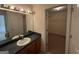 Bathroom featuring a large mirror, vanity, and access to a shelved closet at 191 Tumlin Creek Rd # 1, Roopville, GA 30170