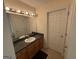 Well-lit bathroom featuring a spacious vanity, mirror and wood cabinets at 191 Tumlin Creek Rd # 1, Roopville, GA 30170