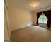 Bedroom with plush carpeting, a window with brown drapes, and neutral walls creating a cozy space at 191 Tumlin Creek Rd # 1, Roopville, GA 30170
