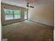 Spacious bedroom with neutral carpet, ceiling fan, and access to private outdoor deck at 191 Tumlin Creek Rd # 1, Roopville, GA 30170