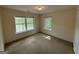 Comfortable bedroom with carpet, two windows offering natural light, and a calming atmosphere at 191 Tumlin Creek Rd # 1, Roopville, GA 30170