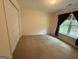 Carpeted bedroom featuring a window with natural light and a spacious closet at 191 Tumlin Creek Rd # 1, Roopville, GA 30170