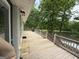 Expansive wooden deck overlooking a serene lake view surrounded by mature trees, perfect for outdoor enjoyment at 191 Tumlin Creek Rd # 1, Roopville, GA 30170