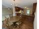 Inviting dining area with a round table and chairs, adjacent to the open kitchen with wood cabinets at 191 Tumlin Creek Rd # 1, Roopville, GA 30170