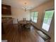 Dining room with hardwood floors, modern chandelier, and view of lake from dining table at 191 Tumlin Creek Rd # 1, Roopville, GA 30170