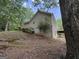 Exterior side view showing house on a gentle slope with a view of the large backyard deck at 191 Tumlin Creek Rd # 1, Roopville, GA 30170