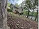 Exterior view of the house on a wooded hillside, showcasing the natural surroundings and privacy at 191 Tumlin Creek Rd # 1, Roopville, GA 30170
