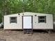 Exterior shot of mobile home with small porch and steps at 191 Tumlin Creek Rd # 1, Roopville, GA 30170