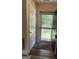 Foyer with a view to exterior grounds beyond storm door, features hardwood floors and tan walls at 191 Tumlin Creek Rd # 1, Roopville, GA 30170