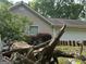 Exterior shot of a home featuring vinyl siding, a garage, and some mature bushes at 191 Tumlin Creek Rd # 1, Roopville, GA 30170