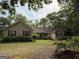 Charming one-story home with red shutters and well-manicured lawn in a peaceful, wooded setting at 191 Tumlin Creek Rd # 1, Roopville, GA 30170