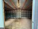 Spacious garage interior with metal roof, wooden beams, and open shelving at 191 Tumlin Creek Rd # 1, Roopville, GA 30170