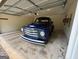 The garage houses a well-maintained vintage vehicle, blending utility with character at 191 Tumlin Creek Rd # 1, Roopville, GA 30170