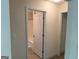 Hallway view leading to the bathroom, showcasing neutral tones and a glimpse of the tub at 191 Tumlin Creek Rd # 1, Roopville, GA 30170