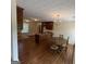 Kitchen featuring dark wood cabinets, an island, and a round dining table with chairs at 191 Tumlin Creek Rd # 1, Roopville, GA 30170
