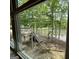 Window view of a lakefront yard with trees and stairs leading to the lake from interior of home at 191 Tumlin Creek Rd # 1, Roopville, GA 30170