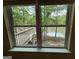 Window view showcasing serene lake and wooden deck amidst lush greenery at 191 Tumlin Creek Rd # 1, Roopville, GA 30170