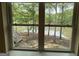 Window view of a lakefront yard with trees, steps leading to the lake, and a bright sunny day at 191 Tumlin Creek Rd # 1, Roopville, GA 30170