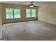 Spacious living room featuring large windows offering scenic views and plush carpeting at 191 Tumlin Creek Rd # 1, Roopville, GA 30170