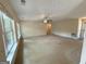 Spacious living room with carpet flooring, ceiling fan, and natural light from multiple windows at 191 Tumlin Creek Rd # 1, Roopville, GA 30170