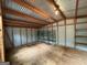 Spacious storage shed with shelving and wood flooring, offering ample room for tools and equipment at 191 Tumlin Creek Rd # 1, Roopville, GA 30170