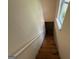 Wooden staircase leading down to a room with a window, offering natural light at 191 Tumlin Creek Rd # 1, Roopville, GA 30170