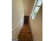 Bright stairway features wooden steps and a window with natural light at 191 Tumlin Creek Rd # 1, Roopville, GA 30170