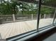 A view to the deck and lake from a large window provides a glimpse of outdoor living at 191 Tumlin Creek Rd # 1, Roopville, GA 30170
