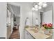 Cozy bathroom with a marble vanity, decorative flowers, and a bright mirror at 9055 Carroll Manor Dr, Sandy Springs, GA 30350