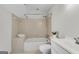 Bathroom features a tub and shower, tile surround, and built in towel shelving at 9055 Carroll Manor Dr, Sandy Springs, GA 30350