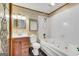 Bathroom with white tile tub, sink vanity, and tiled floor at 9055 Carroll Manor Dr, Sandy Springs, GA 30350