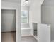Bright hallway featuring a window seat, access to under-stairs storage, and a separate closet at 9055 Carroll Manor Dr, Sandy Springs, GA 30350