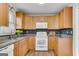 Updated kitchen with wood cabinets, granite counters, and modern appliances at 9055 Carroll Manor Dr, Sandy Springs, GA 30350