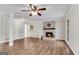 Spacious living room with hardwood floors, a ceiling fan, and a fireplace at 9055 Carroll Manor Dr, Sandy Springs, GA 30350