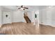 Spacious room with neutral walls, hardwood floors, a stairway and entry to another area at 9055 Carroll Manor Dr, Sandy Springs, GA 30350