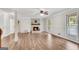 Bright living room featuring hardwood floors, a fireplace, and ample natural light at 9055 Carroll Manor Dr, Sandy Springs, GA 30350