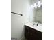 Functional bathroom features a single sink vanity with a dark wood cabinet, a large mirror, and modern lighting at 2517 Oakleaf Rdg, Lithonia, GA 30058