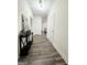 Inviting hallway with wood-look floors, neutral walls, and a stylish console table with decorative accents at 2517 Oakleaf Rdg, Lithonia, GA 30058
