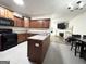Well-equipped kitchen with wood cabinets, black appliances, and open to the living room is great for entertaining at 2517 Oakleaf Rdg, Lithonia, GA 30058