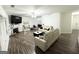 Bright living room with hardwood floors, white sofas, fireplace, and a ceiling fan creates an inviting space at 2517 Oakleaf Rdg, Lithonia, GA 30058