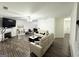Bright living room with hardwood floors, white sofas, fireplace, and a ceiling fan creates an inviting space at 2517 Oakleaf Rdg, Lithonia, GA 30058