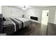 Comfortable bedroom featuring wood-look floors, neutral paint colors, a fireplace, and access to the en-suite bathroom at 2517 Oakleaf Rdg, Lithonia, GA 30058