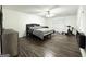 Spacious bedroom featuring wood-look floors, ceiling fan, and neutral paint colors at 2517 Oakleaf Rdg, Lithonia, GA 30058
