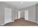 Bright bedroom with modern gray paint, and a wood floor with multiple doors at 5326 Tolar Rd # 29, South Fulton, GA 30213