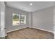 Sun-filled bedroom featuring wood-look flooring and two large windows at 5326 Tolar Rd # 29, South Fulton, GA 30213