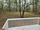 View of a serene backyard from the deck, showcasing mature trees and natural landscaping at 4687 Sterling Pointe Ct, Douglasville, GA 30135