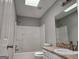 Clean bathroom featuring a shower-tub combo, granite countertop vanity and a skylight at 4687 Sterling Pointe Ct, Douglasville, GA 30135
