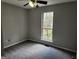 Bedroom with natural light through a window, neutral paint, and updated carpet at 4687 Sterling Pointe Ct, Douglasville, GA 30135