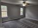 Bright bedroom with dual windows offering natural light and scenic outdoor views at 4687 Sterling Pointe Ct, Douglasville, GA 30135